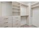 Walk-in closet with wood shelves, drawers, and gold hardware at 3473 Shoal Oak Ct, Riverdale, GA 30296