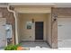 Inviting front entrance with brick accents and attached one-car garage at 3473 Shoal Oak Ct, Riverdale, GA 30296