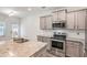 Kitchen with stainless appliances, stone countertops and updated cabinets at 3473 Shoal Oak Ct, Riverdale, GA 30296