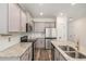 Kitchen with stainless appliances, stone countertops and updated cabinets at 3473 Shoal Oak Ct, Riverdale, GA 30296