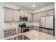 Modern kitchen featuring stainless appliances, gray cabinets, and granite countertops at 3473 Shoal Oak Ct, Riverdale, GA 30296