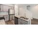 Open-concept kitchen featuring stainless appliances, a kitchen island, and access to the staircase at 3473 Shoal Oak Ct, Riverdale, GA 30296