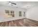 Bright living room featuring hardwood floors, ceiling fan and natural light at 3473 Shoal Oak Ct, Riverdale, GA 30296