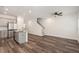 Open-concept living space with hardwood floors, kitchen, and staircase at 3473 Shoal Oak Ct, Riverdale, GA 30296