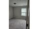 A well-lit bedroom with plush carpeting and a bright window at 6585 Story Cir, Norcross, GA 30093