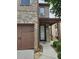 Brick home featuring a garage and covered front entry at 6585 Story Cir, Norcross, GA 30093