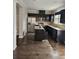 A modern kitchen featuring granite countertops, stainless appliances and dark cabinets at 6585 Story Cir, Norcross, GA 30093