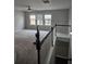 Bright living room with large windows, neutral carpet, and ceiling fan at 6585 Story Cir, Norcross, GA 30093