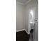 A quaint powder room featuring dark wood flooring, a pedestal sink, and a decorative mirror at 6585 Story Cir, Norcross, GA 30093