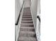 Carpeted stairway leading to the upper levels of the home at 6585 Story Cir, Norcross, GA 30093