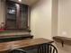 Charming basement bar area with a custom cabinet, wooden countertop, and comfortable seating at 107 Sedgefield Overlook, Dallas, GA 30157
