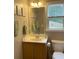Bathroom featuring a single vanity, window, and decorative wall art at 107 Sedgefield Overlook, Dallas, GA 30157