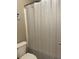 Bathroom showcasing a toilet and patterned shower curtain; this is a small private space in this home at 107 Sedgefield Overlook, Dallas, GA 30157