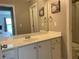 Bright bathroom with white vanity, a large mirror, and neutral walls, exuding a clean ambiance at 107 Sedgefield Overlook, Dallas, GA 30157