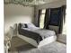 Bedroom featuring a bed, a desk and leafy decorations at 107 Sedgefield Overlook, Dallas, GA 30157