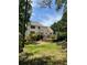 Expansive backyard featuring a multi-tiered layout with stone retaining walls and lush greenery at 107 Sedgefield Overlook, Dallas, GA 30157