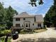 Home with a deck and well-maintained landscaping in a lush, wooded setting at 107 Sedgefield Overlook, Dallas, GA 30157