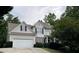 Traditional two-story home with an attached garage, manicured lawn, and classic architectural details at 107 Sedgefield Overlook, Dallas, GA 30157