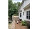 The exterior side of the house features white siding, a deck and manicured landscaping at 107 Sedgefield Overlook, Dallas, GA 30157