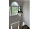 A view of the home's two-story entryway featuring a decorative light fixture and window at 107 Sedgefield Overlook, Dallas, GA 30157