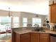 Kitchen with granite countertops, wooden cabinets and casual breakfast nook at 107 Sedgefield Overlook, Dallas, GA 30157