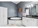 Elegant bathroom features a soaking tub, vanity, storage cabinets, and stylish mirror at 1717 N Decatur Ne Rd # 322, Atlanta, GA 30307