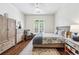 Cozy bedroom features hardwood floors, a ceiling fan, neutral colors, and natural lighting at 1717 N Decatur Ne Rd # 322, Atlanta, GA 30307