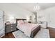 Charming bedroom features a cozy bed, chandelier lighting, and elegant decor at 1717 N Decatur Ne Rd # 322, Atlanta, GA 30307