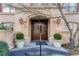 Grand entrance featuring a beautiful arched doorway, decorative sconces, and meticulously maintained landscaping at 1717 N Decatur Ne Rd # 322, Atlanta, GA 30307