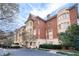 Classic brick condo building featuring manicured landscaping and elegant architectural details at 1717 N Decatur Ne Rd # 322, Atlanta, GA 30307