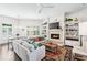 Bright living room with a cozy fireplace, custom built-ins, and a large sectional sofa perfect for entertaining at 1717 N Decatur Ne Rd # 322, Atlanta, GA 30307