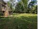 View of the backyard with stairs leading from the deck, complemented by mature trees at 5882 Grandview Nw Ct, Acworth, GA 30101