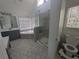 Bathroom featuring a glass-enclosed shower, garden tub, and neutral tiling at 5882 Grandview Nw Ct, Acworth, GA 30101