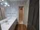 Bathroom showcasing a patterned wallpaper, vanity, and tub at 5882 Grandview Nw Ct, Acworth, GA 30101