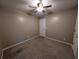 Neutral bedroom with tan carpet, white trim, and a ceiling fan at 5882 Grandview Nw Ct, Acworth, GA 30101