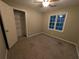 Neutral bedroom features carpet, ceiling fan, closet, and natural light from the window at 5882 Grandview Nw Ct, Acworth, GA 30101