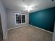 Bedroom featuring neutral walls, an accent wall, a ceiling fan, carpet, and natural light at 5882 Grandview Nw Ct, Acworth, GA 30101