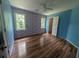 Bright bedroom with wood floors, floral wallpaper, white trim, and natural light from two windows at 5882 Grandview Nw Ct, Acworth, GA 30101
