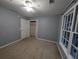 Bedroom with neutral walls, a ceiling fan, double-hung window, carpet, and a closet at 5882 Grandview Nw Ct, Acworth, GA 30101