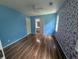 Bright bedroom with blue walls and hardwood floors adjacent to a bathroom for added convenience at 5882 Grandview Nw Ct, Acworth, GA 30101