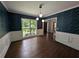 Elegant dining room featuring wainscoting, decorative wallpaper, and hardwood floors at 5882 Grandview Nw Ct, Acworth, GA 30101