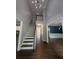 Bright foyer with hardwood floors, staircase, and view into the dining room at 5882 Grandview Nw Ct, Acworth, GA 30101