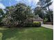 Charming brick home with a two-car garage, lush greenery, and flowering trees at 5882 Grandview Nw Ct, Acworth, GA 30101