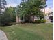 Beautiful front lawn and landscaping, brick house with shrubbery and large trees at 5882 Grandview Nw Ct, Acworth, GA 30101