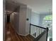Upstairs hallway showcasing wood floors, crown molding, and natural light at 5882 Grandview Nw Ct, Acworth, GA 30101
