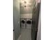 Well-lit laundry room with tiled floor, cabinets, and side-by-side washer and dryer at 5882 Grandview Nw Ct, Acworth, GA 30101
