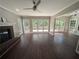 Spacious living room with hardwood floors, fireplace, and a wall of windows to the outdoor deck at 5882 Grandview Nw Ct, Acworth, GA 30101