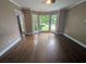 Sunlit living room with hardwood floors and a charming bay window area at 5882 Grandview Nw Ct, Acworth, GA 30101