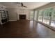 Bright living room featuring hardwood floors, fireplace, and large windows with outdoor access at 5882 Grandview Nw Ct, Acworth, GA 30101