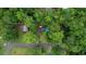 Aerial view of the property showing a house nestled among lush green trees on a large lot at 749 Dogwood Dr, Lawrenceville, GA 30046